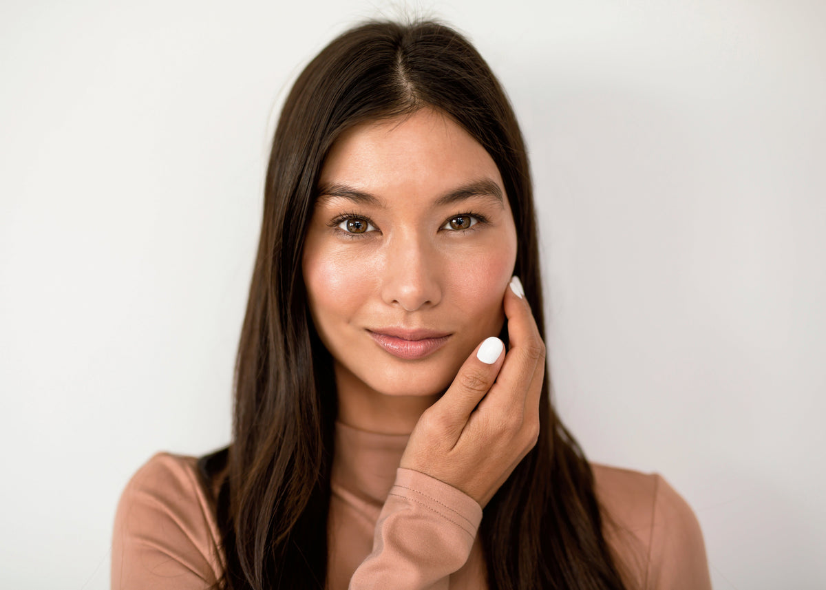 Woman cupping face with her hand