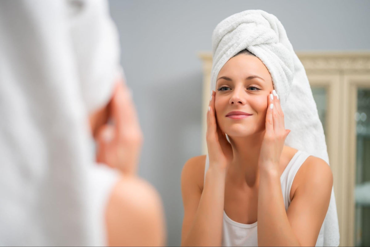 Woman assessing her aging skin