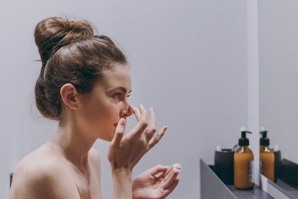Young woman doing her skincare routine.