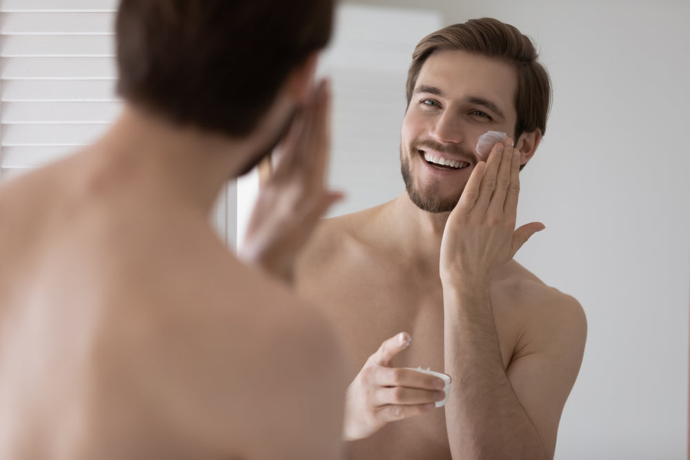 Man applying skin treatment to his face.