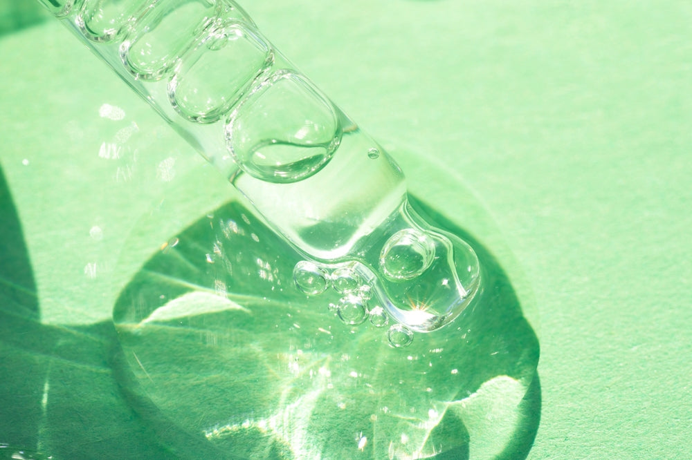 Squalane oil on green background.