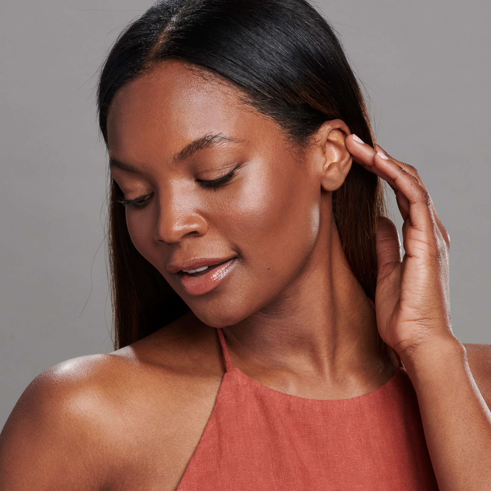 Woman with dark skin tone wearing Sunforgettable® Total Protection™ Face Shield Bronze SPF 50 || all