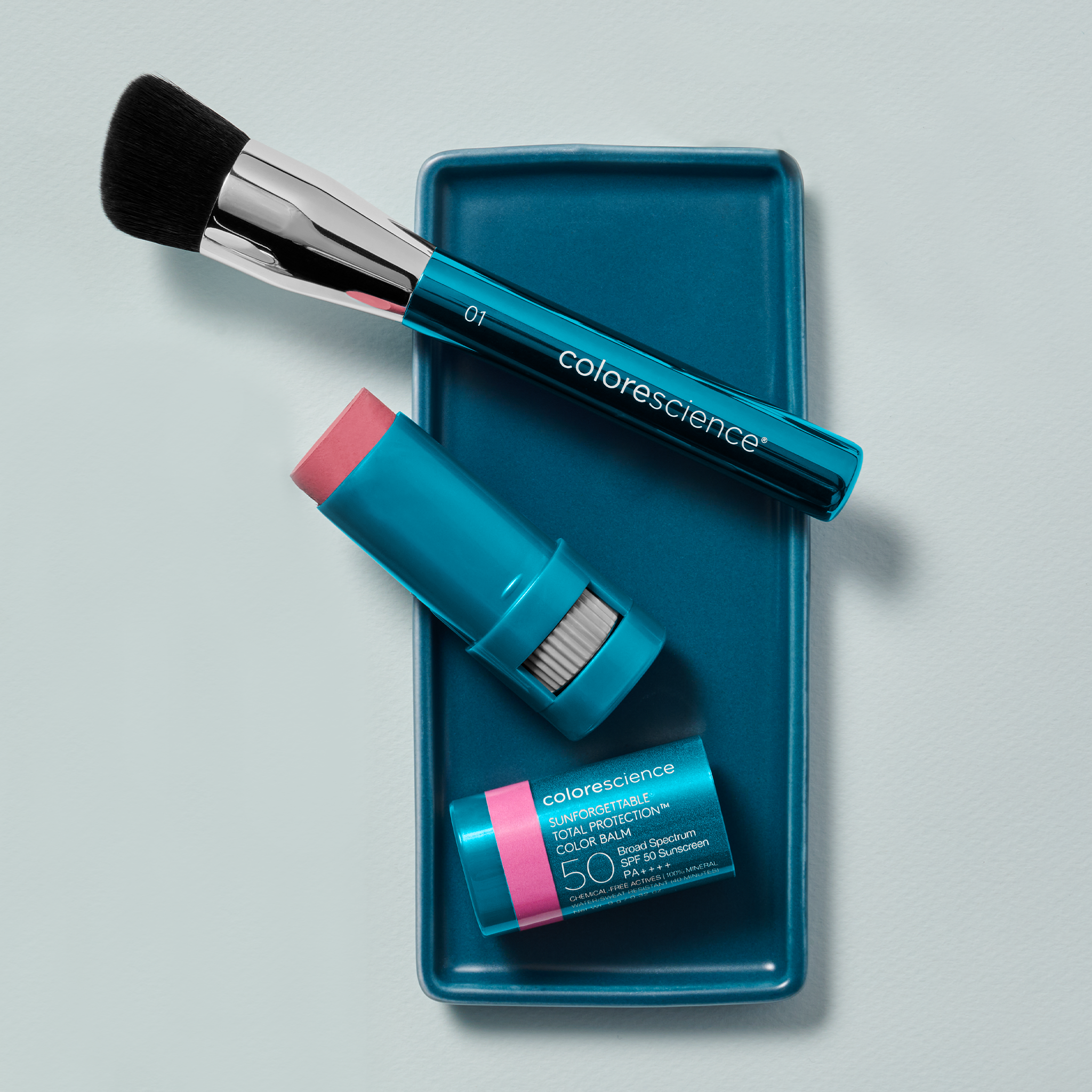 Lay flat image of angled face brush with Color Balm on tray | all