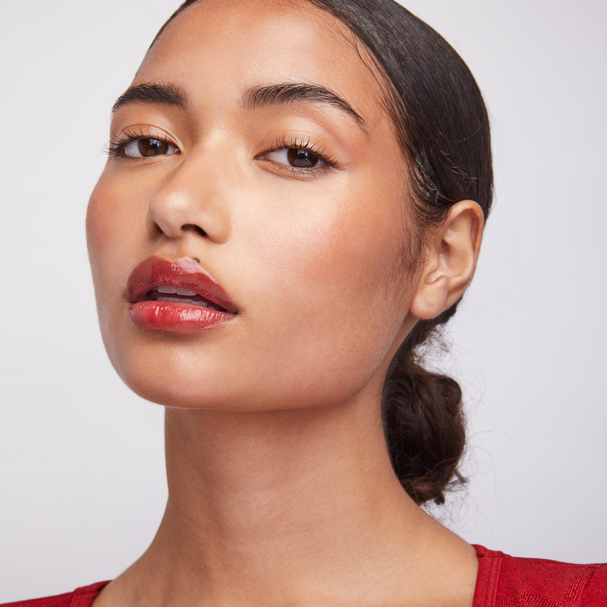 model wearing Lip Shine Scarlet || all