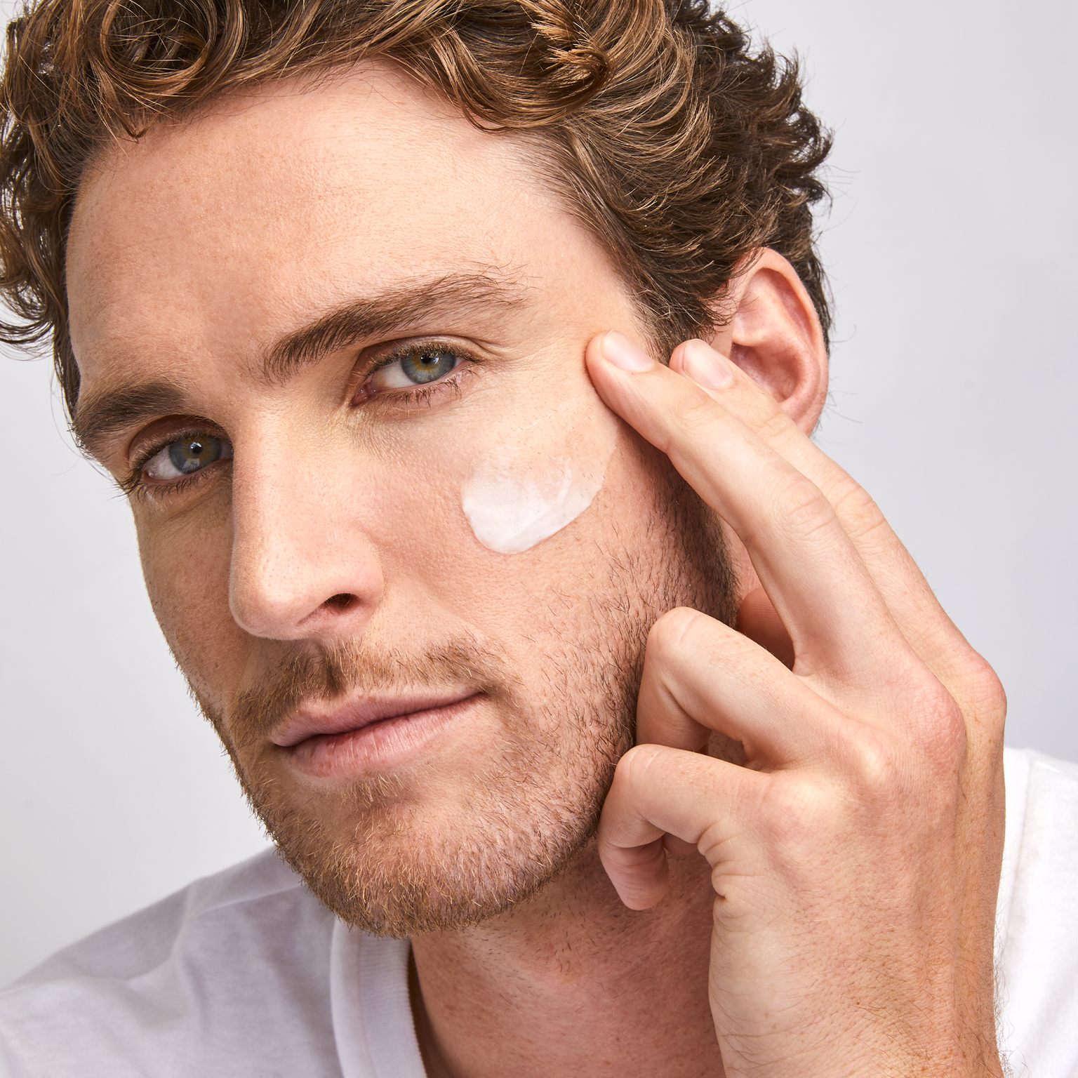 man with a swatch Barrier Pro™ Essential Moisturizer on his cheek || all