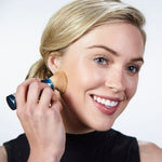 Woman applying brush SPF 50 || all