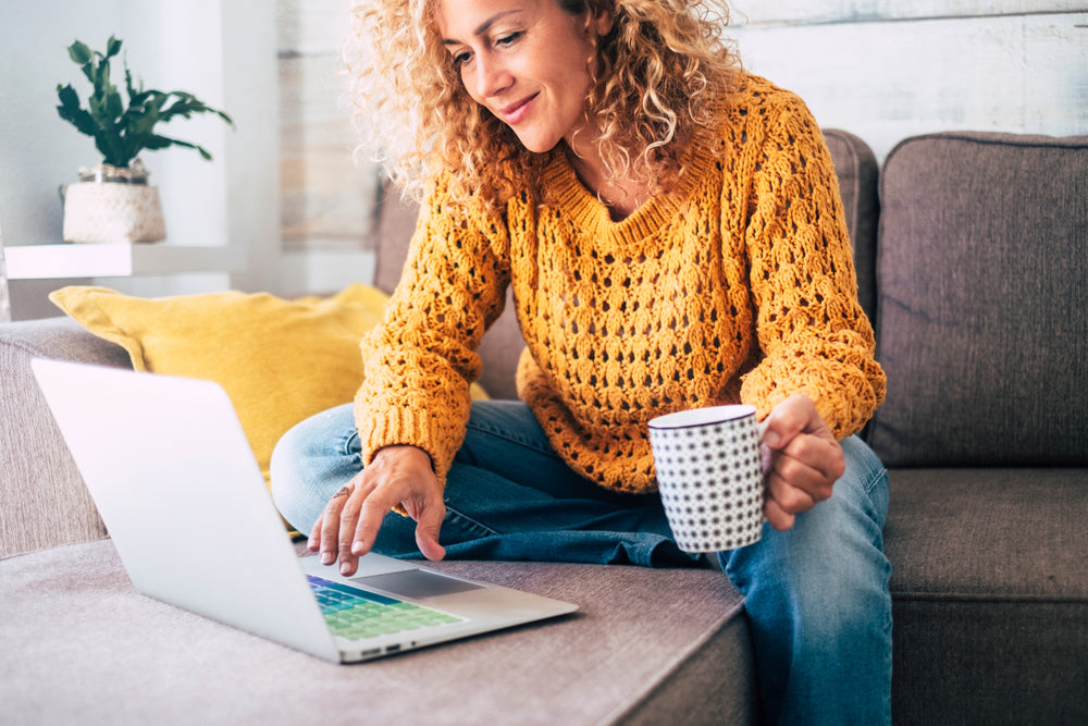 Woman looking at laptop that is emitting blue light