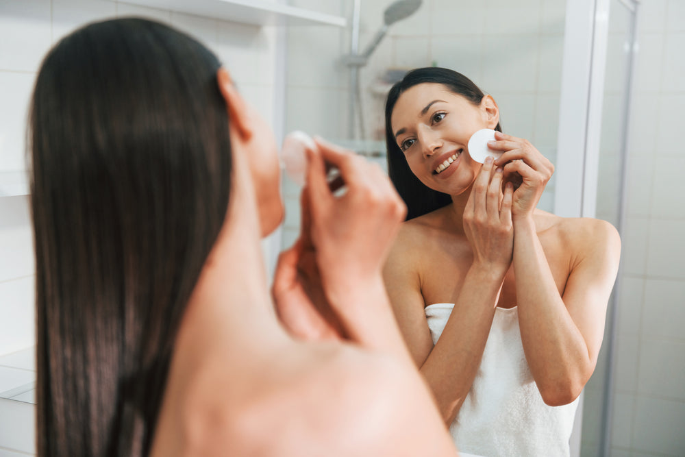 Woman using skincare products on her face