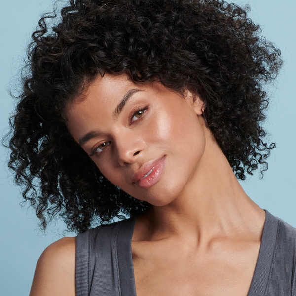 Woman  with medium skin tone wearing Sunforgettable® Total Protection™ Face Shield Bronze SPF 50