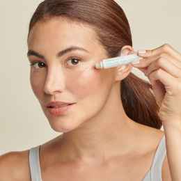 Woman applying Total Eye Concentrate Serum