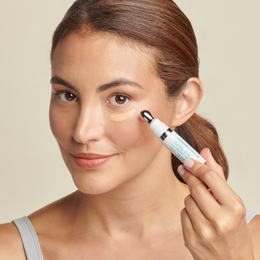 Woman applying Total Eye 3-in-1 Renewal Therapy SPF 35