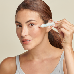 Woman applying Total Eye Concentrate Serum