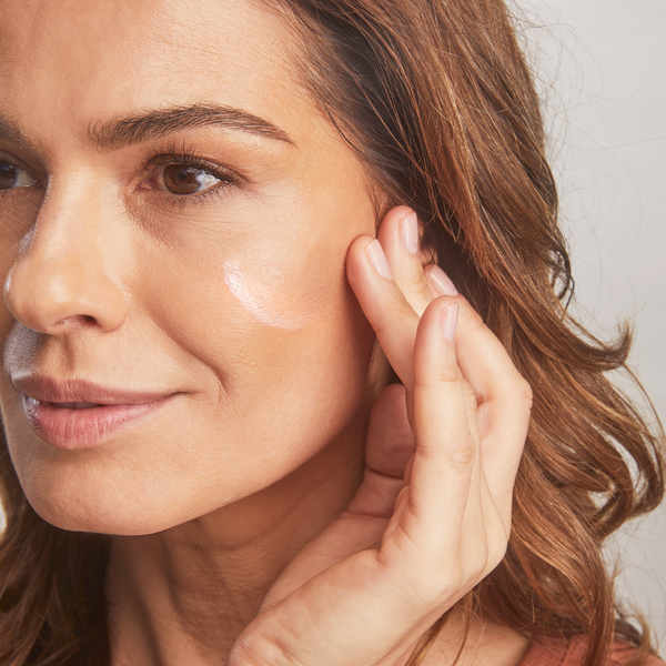 Model applying Total Protection™ No Show™ Mineral Sunscreen SPF 50