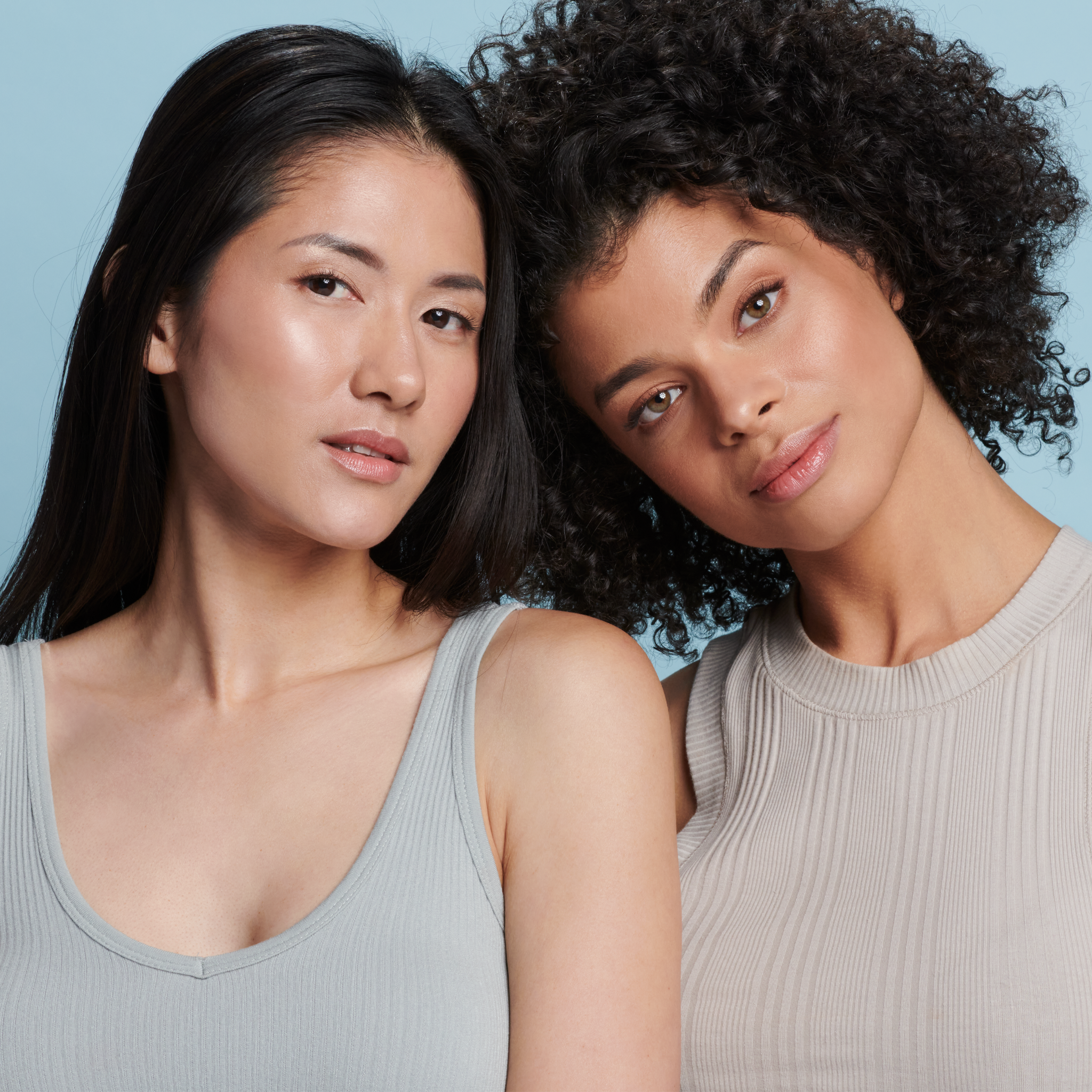 Two women, one with fair and one with deep skin tone wearing Sunforgettable® Total Protection™ Face Shield Classic SPF 50 || all