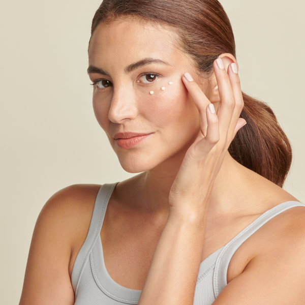 woman applying Total Eye cream