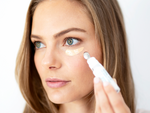 Woman applying Total Eye 3-in-1 Renewal Therapy SPF 35 || all